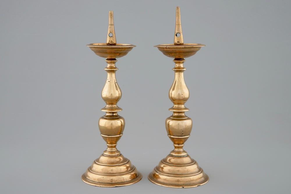 A pair of bronze pricket candle sticks, early 17th C.