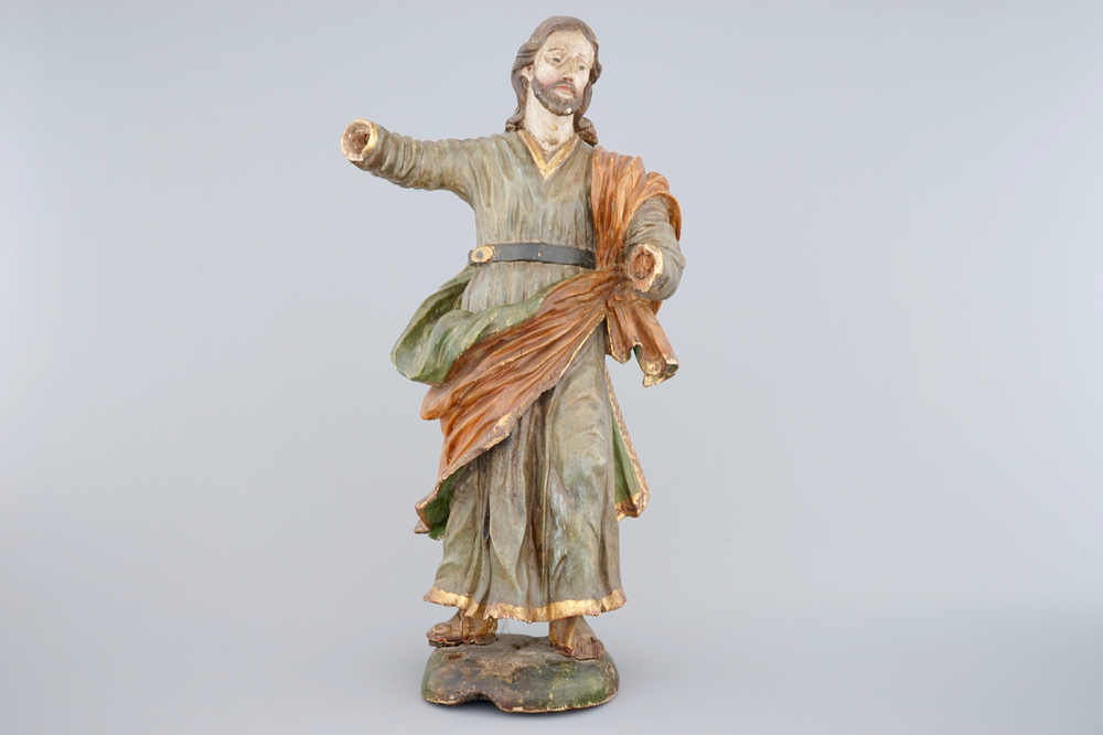 A tall polychrome wood sculpture of a saint, 18th C.