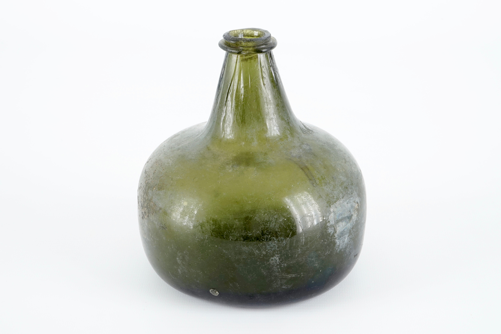 A Dutch green glass wine bottle, 17th C.