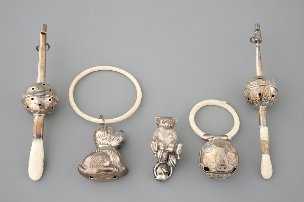 Two rattles and three biting rings in silver and ivory, 18/19th C.