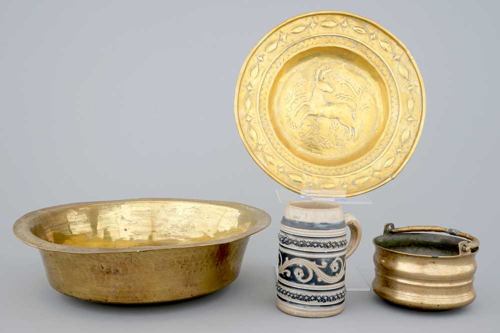 A Malines brass alms dish, a Nuremberg brass alms bowl, an Italian bronze holy water bucket and a Westerwald stoneware beer stein, 16/18th C.
