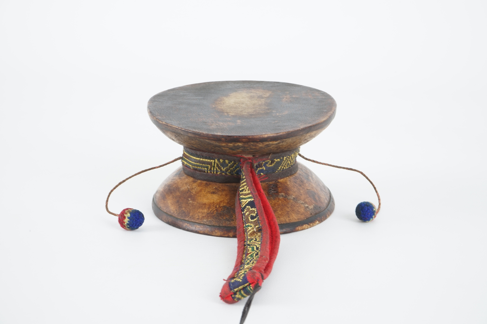 A Tibetan human skull drum, damaru, in original case, Tibet, 18/19th C.