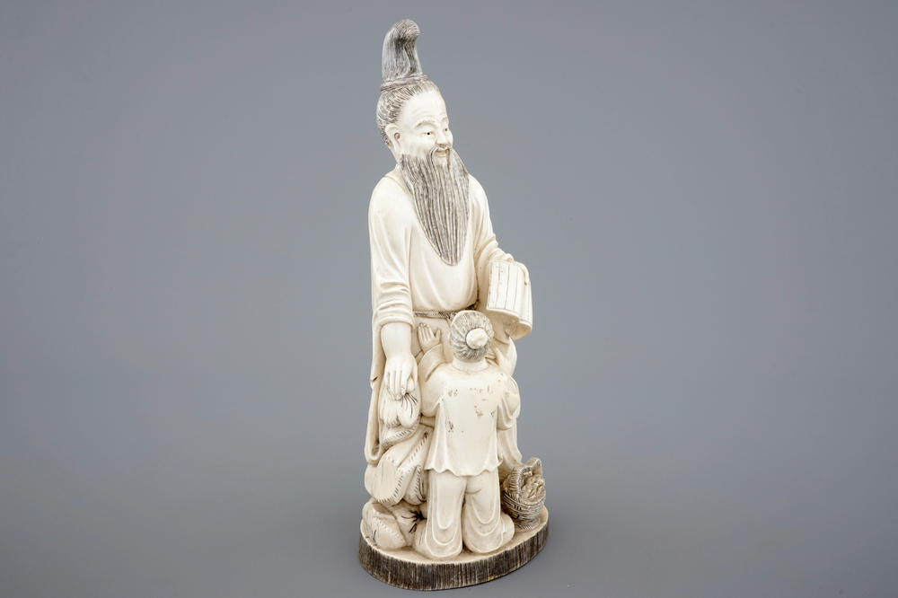 A Chinese carved ivory group of a sage with a child, 19th C.