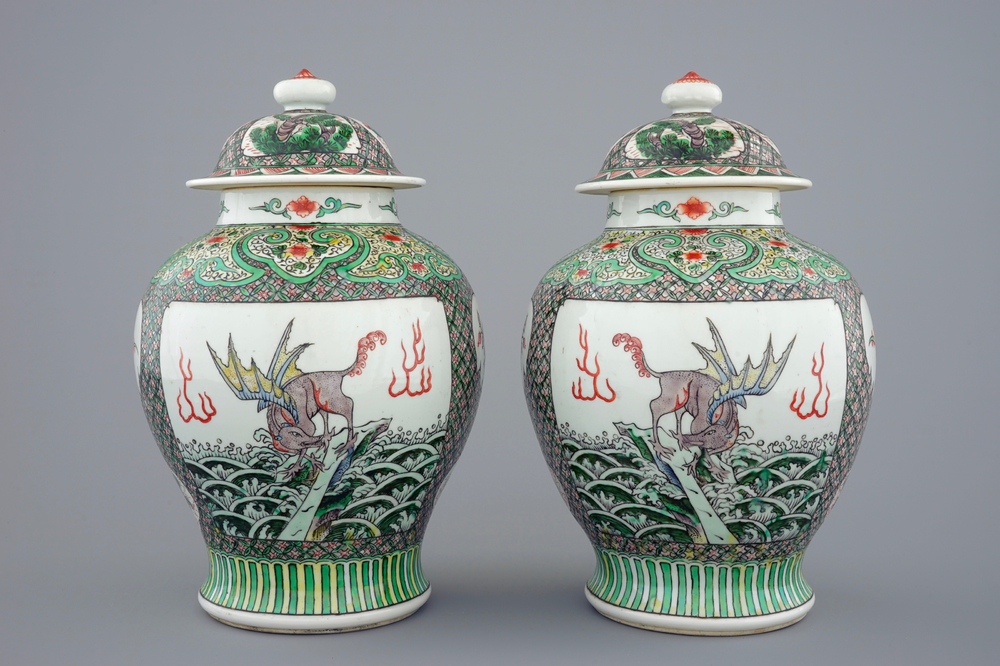 A pair of Chinese famille verte vases and covers with mythical beasts, 19/20th C.