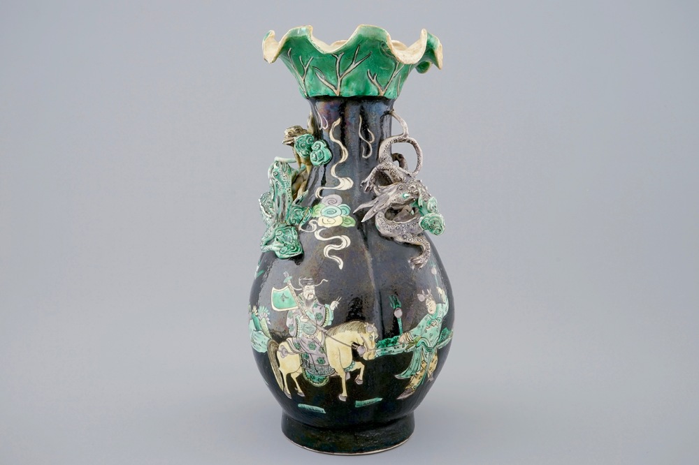 A Chinese famille noire lotus-shaped vase with applied dragons, 19th C.