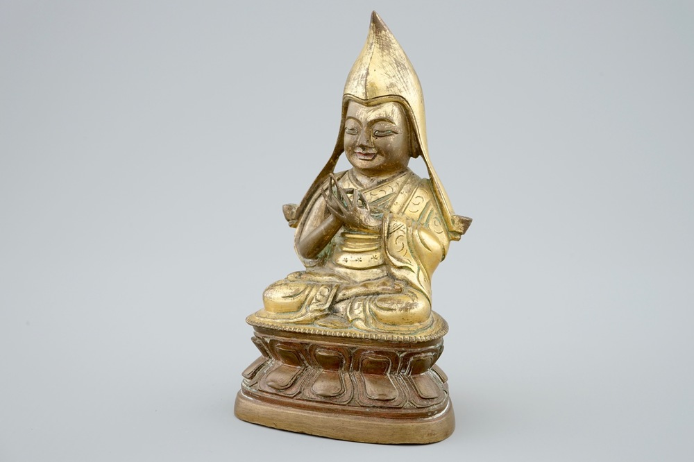 A Sino-Tibetan gilt bronze figure of a Lama on a double lotus throne, 19th C.