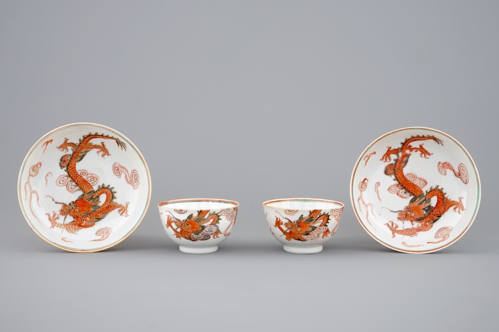 A pair of Chinese cups and saucers with dragons in iron red and gilt, Yongzheng, 1723-1735