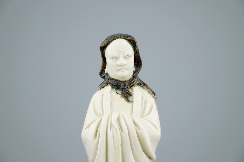 Een ongewone Chinese Dehua blanc de Chine figuur van een Luohan met zwarte shawl, 19e eeuw