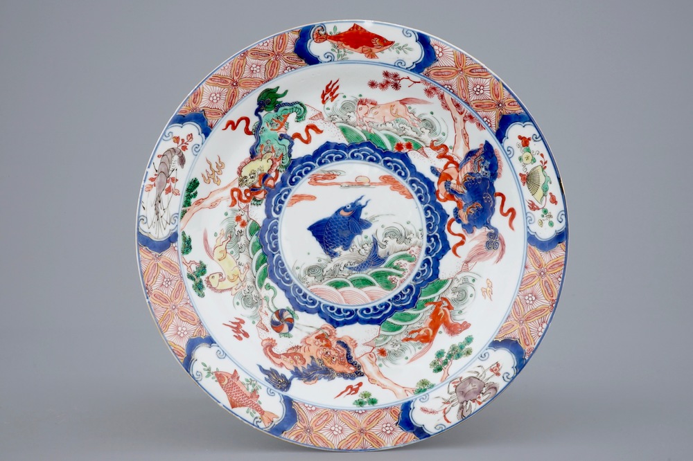 A Chinese famille verte plate with a carp surrounded by horses and buddhist lions, Kangxi