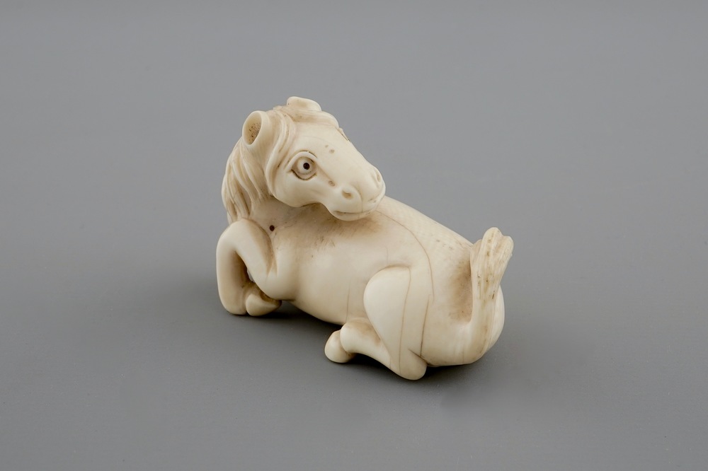 A signed Japanese ivory netsuke of a horse, 19th C.