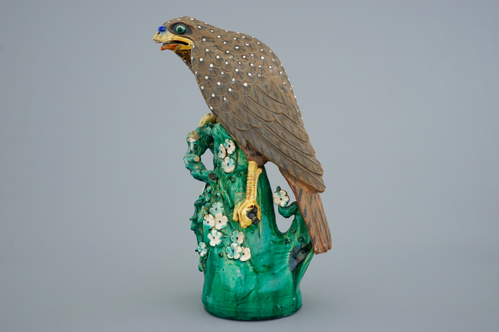 A large Chinese stoneware model of a hawk on a branch, Qianlong, 18th C.