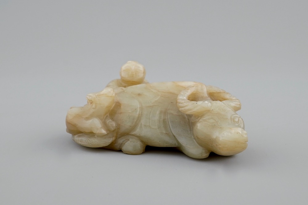 A Chinese jade group of a boy on a buffalo, 18/19th C.