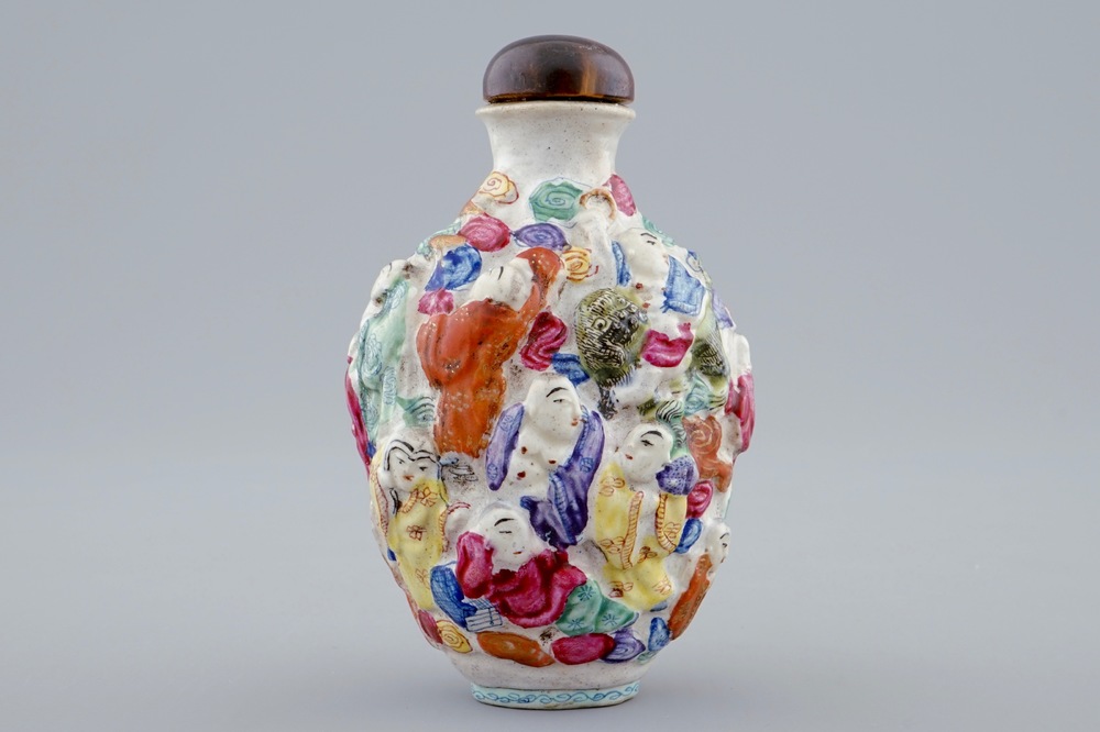 A Chinese famille rose moulded snuff bottle with 18 Luohan, Xianfeng mark and poss. period