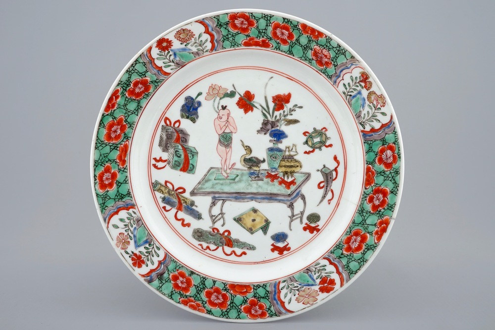 A Chinese famille verte plate with a small boy on a table, Kangxi
