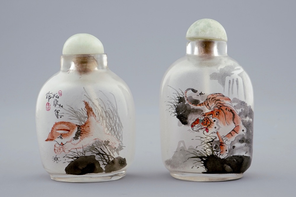 Two Chinese inside-painted glass snuff bottles with a cat and a tiger, 20th C.