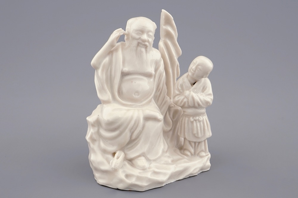 A Chinese Dehua blanc de Chine group of an immortal with a boy, 18/19th C.
