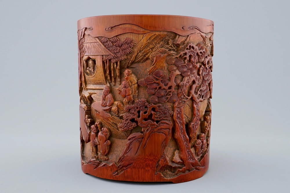 A deeply carved Chinese bamboo brush pot with a mountainous landscape, 18/19th C.