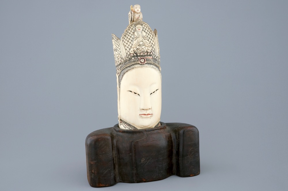 A Chinese carved ivory head of Guanyin on wood stand, 19th C.
