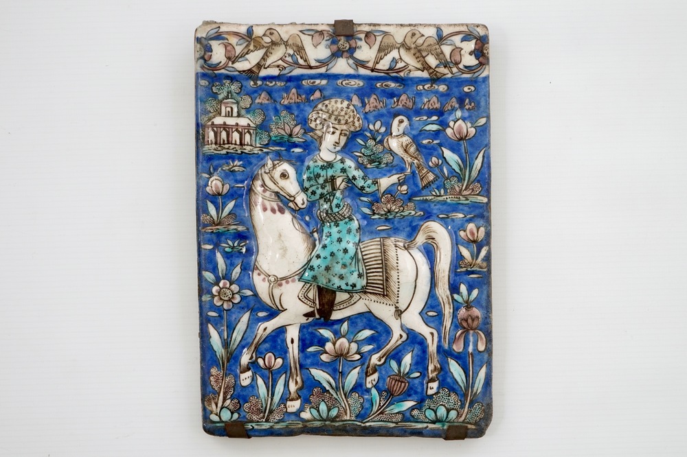 A rectangular moulded tile with a falconer, Qajar, Iran, 19th C.