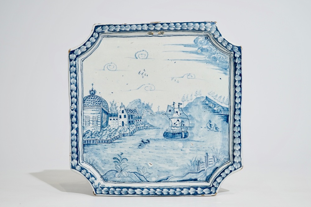 A Dutch Delft blue and white plaque with a large ship along the shore, 18th C.