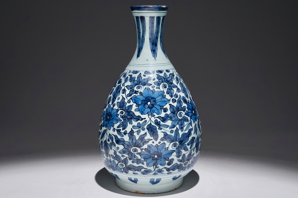 An unusual blue and white Dutch Delft chinoiserie bottle vase with lotus scroll design, late 17th C.