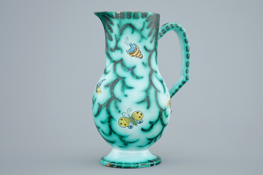 A Brussels faience water jug with butterflies and caterpillars, 18/19th C.