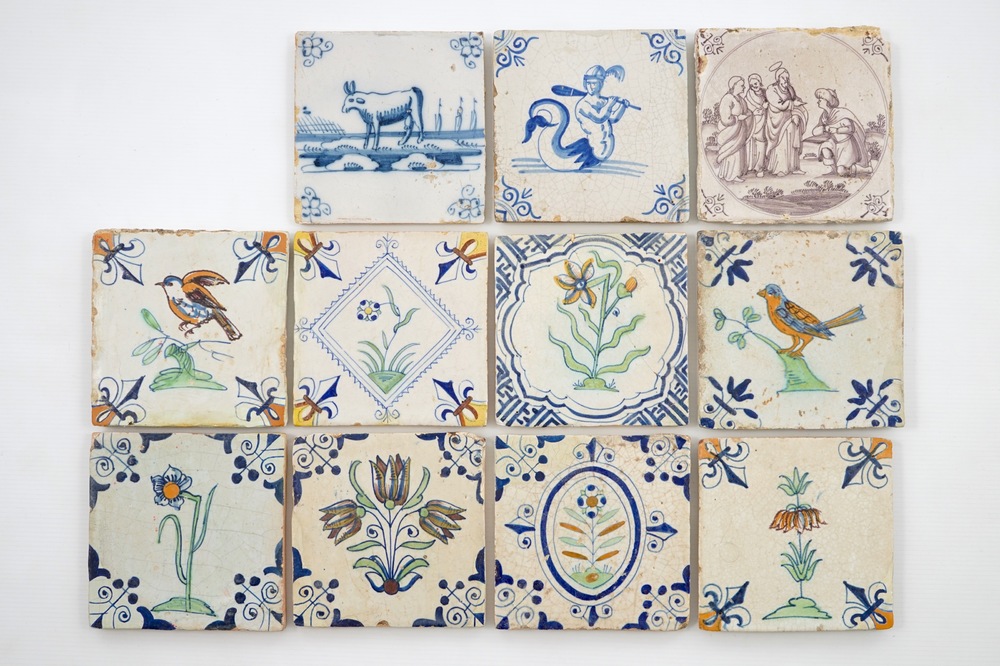Eleven Dutch Delft tiles executed in blue &amp; white, manganese and polychrome enamels, 17/18th C.