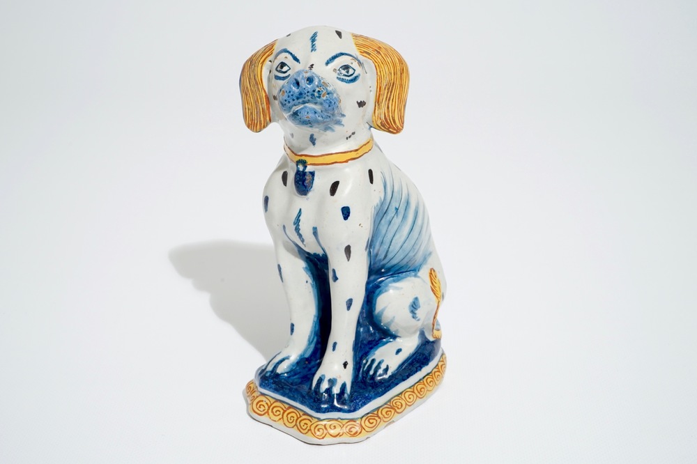 A polychrome Dutch Delft model of a seated dog, 18th C.