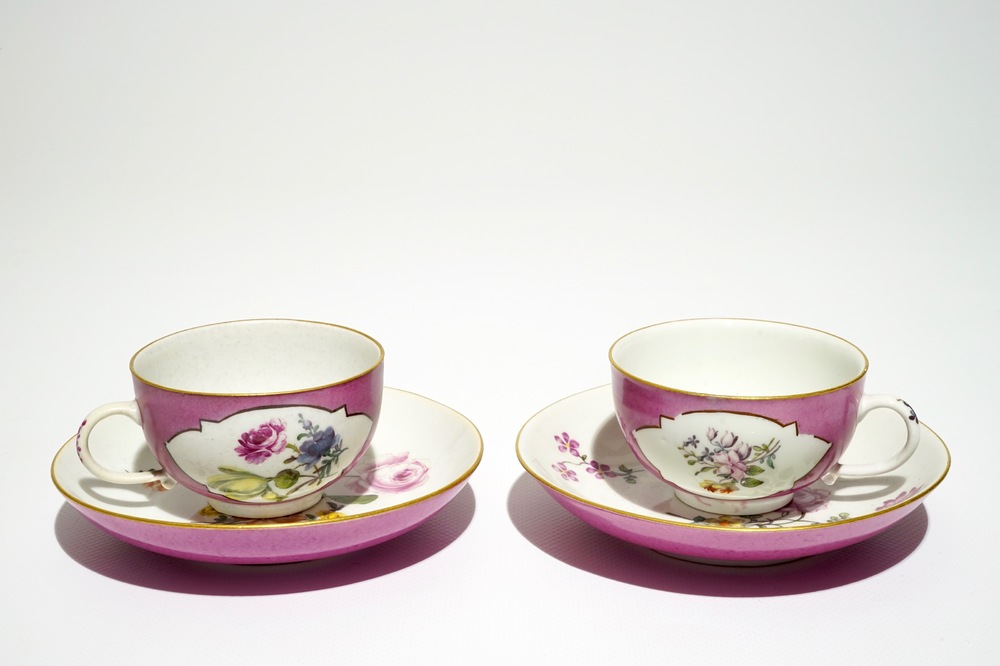 A pair of Meissen ruby ground cups and saucers with floral design, 18th C.