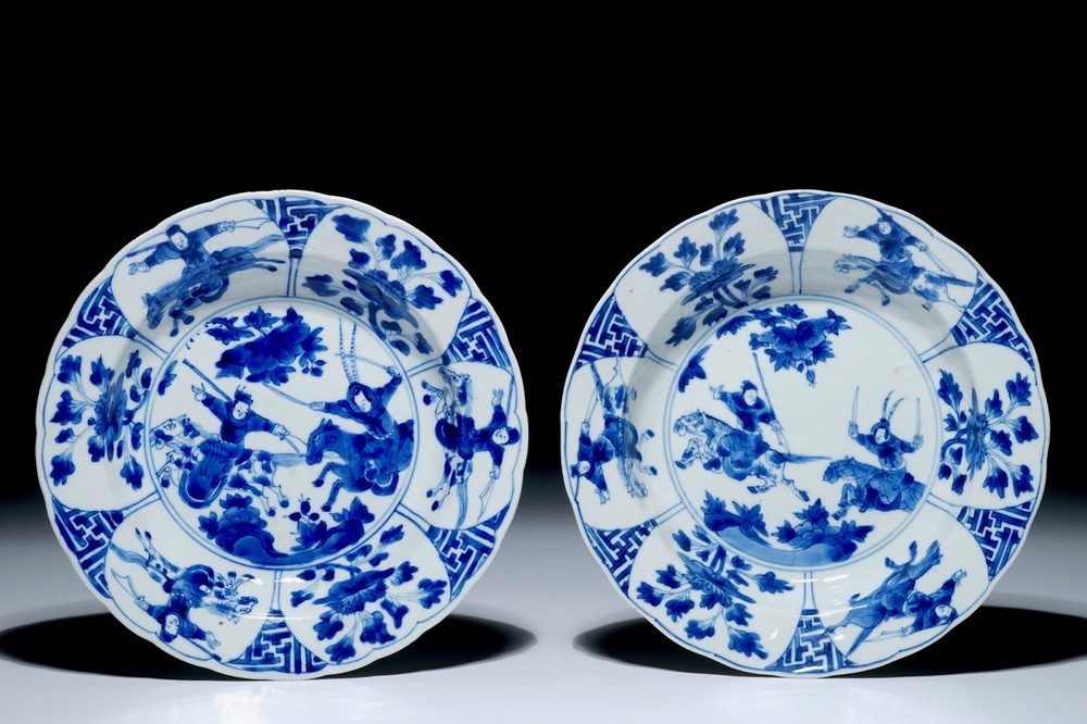 A pair of Chinese blue and white plates with warriors on horseback, Kangxi mark and of the period