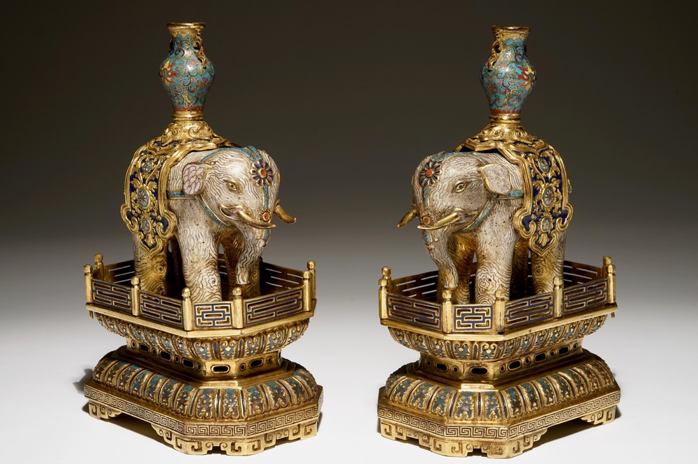A pair of Chinese gilt bronze and cloisonne elephants on stands, 19th C.