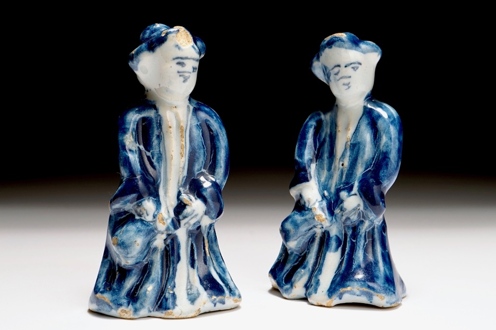 A pair of Dutch Delft blue and white miniatures of men with a jug, 18th C.
