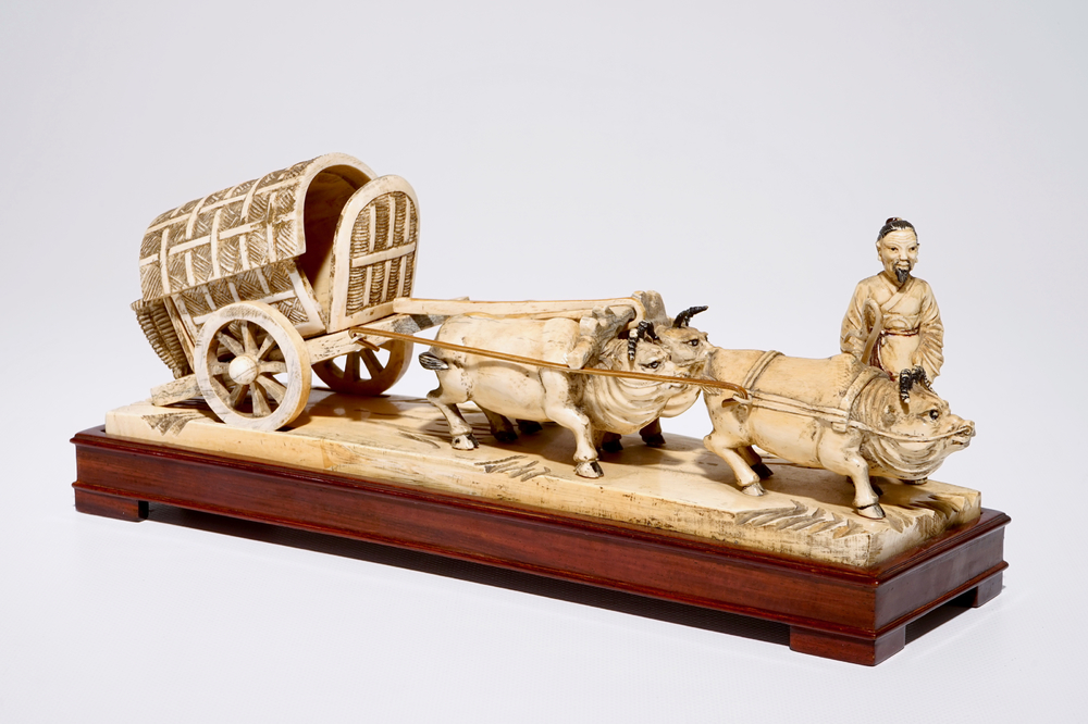 A Chinese carved ivory group of a farmer with buffaloes and a chariot, early 20th C.