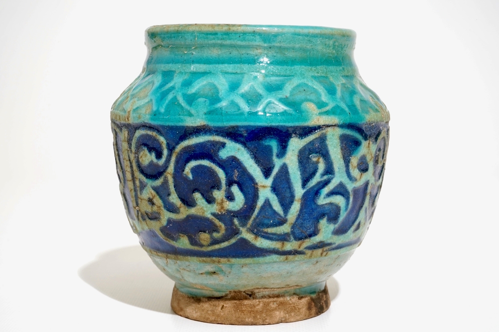 A turquoise and blue glazed calligraphy vase, Kashan, Iran, 12/13th C.