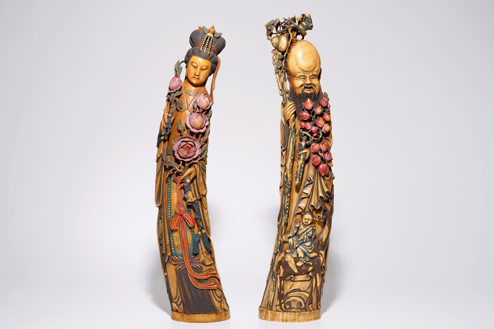 A pair of tall polychrome Chinese carved ivory figures of immortals, 19th C.