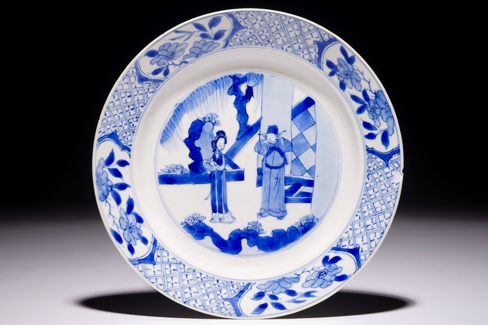 A Chinese blue and white plate with figures in the garden, Kangxi mark and of the period