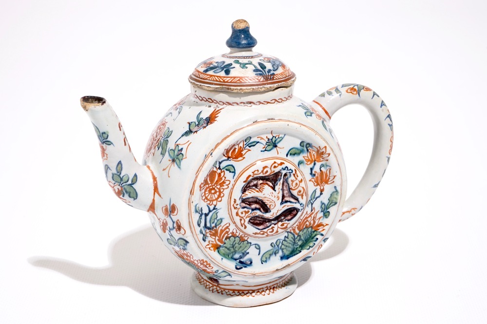 A Dutch Delft cashmire palette teapot with birds and insectes among flowers, early 18th C.