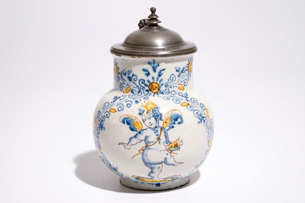 An Italian maiolica compendario style jug with a putto, Faenza, 17th C.