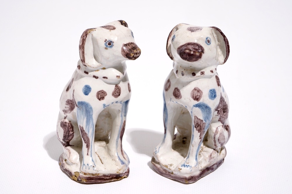 A pair of blue and manganese Brussels faience models of dogs, 18th C.