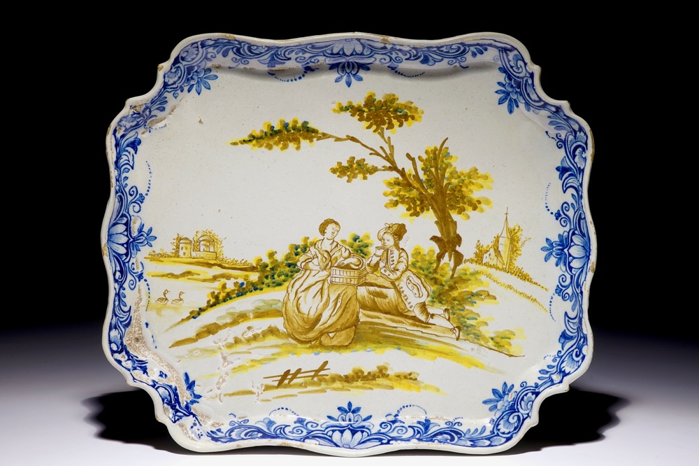A polychrome Dutch Delft serving tray with a romantic scene, 18th C.
