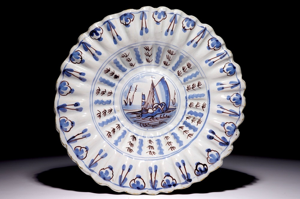 A Dutch Delft blue and manganese lobed dish with a boat, 17/18th C.