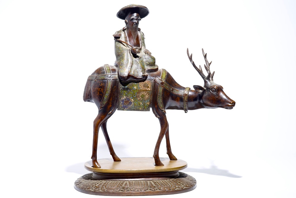 A large Chinese bronze and cloisonn&eacute; model of Shou Lao on a deer, on wooden base, 19/20th C.