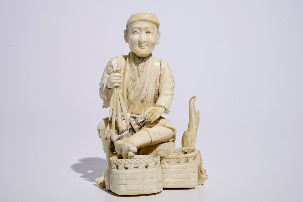 A Japanese ivory okimono of a vegetable seller, Meiji, early 20th C.