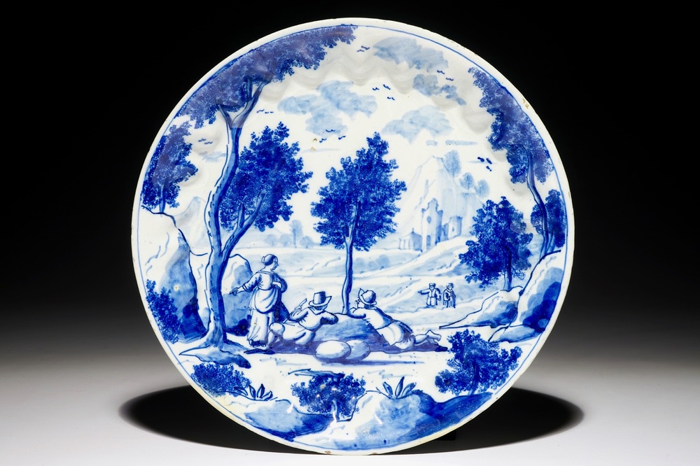 A fine Dutch Delft blue and white plate with travellers in a landscape, early 18th C.