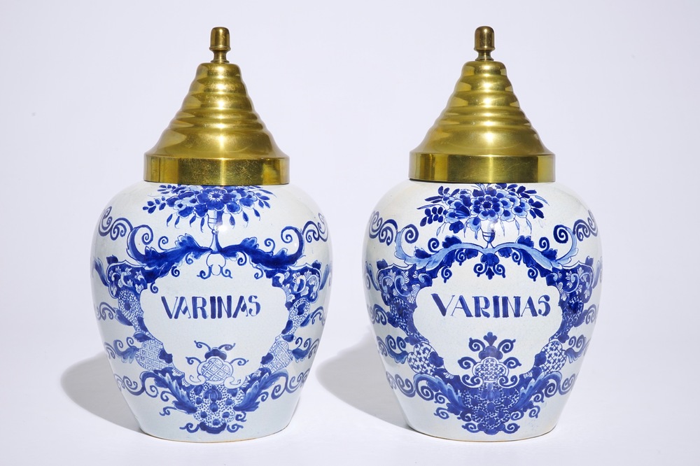 A pair of Dutch Delft blue and white tobacco jars with brass covers, 19th C.