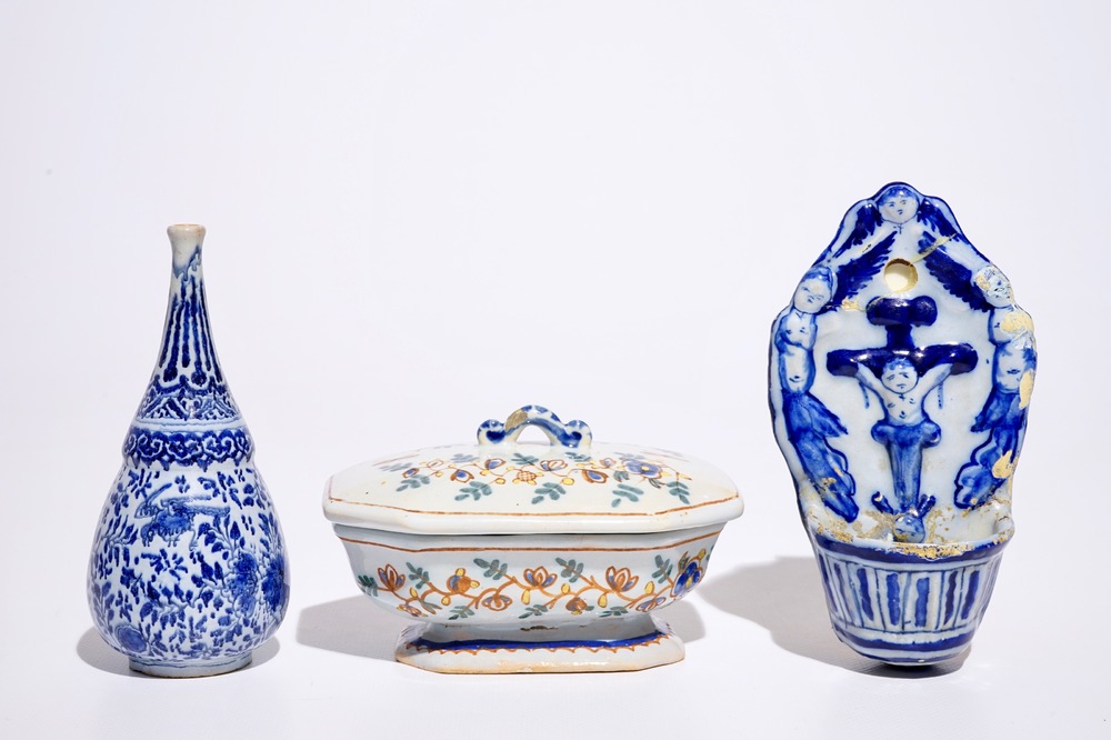 A Dutch Delft blue and white holy water font and a vase, with a polychrome covered spice box, 18th C.