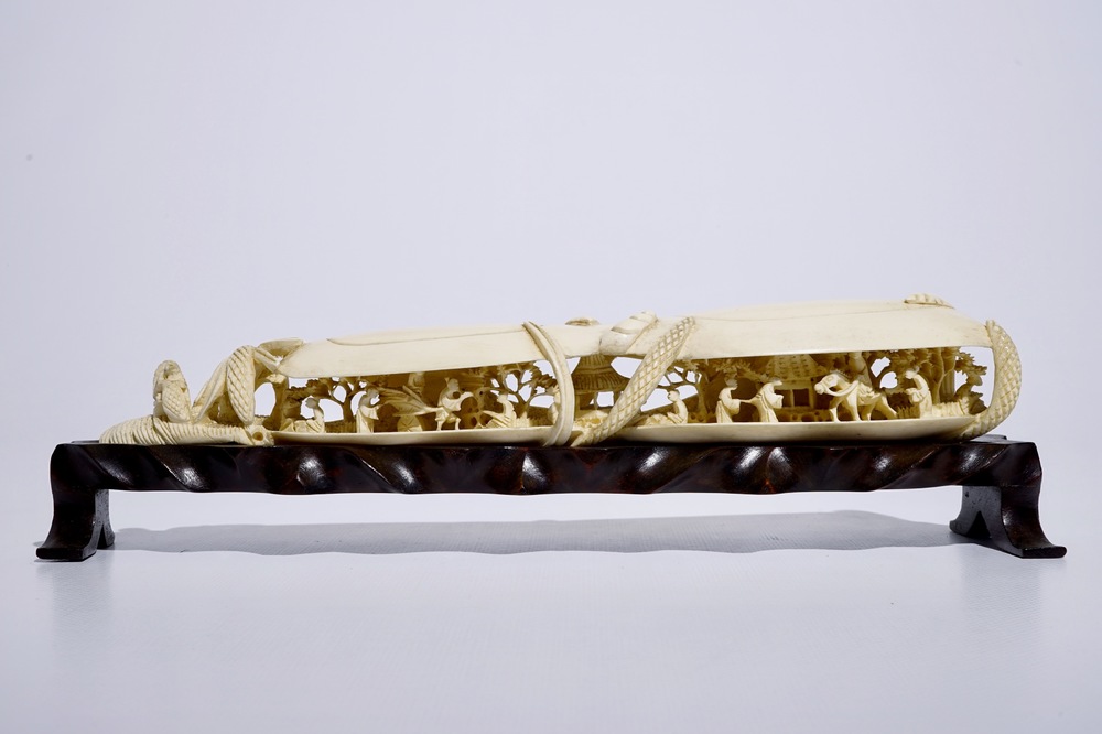 A Chinese shell-shaped ivory group on wooden stand, early 20th C.