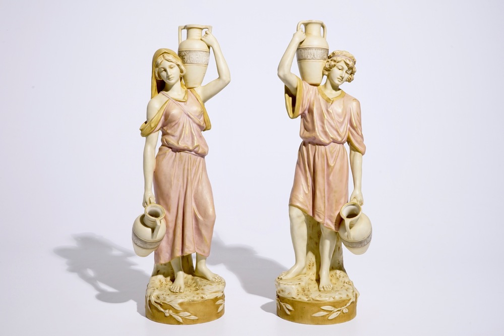 A pair of large Royal Dux Greek style figures carrying jugs, Bohemia, early 20th C.