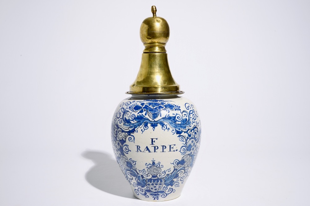 A Dutch Delft blue and white tobacco jar with brass cover, 18th C.