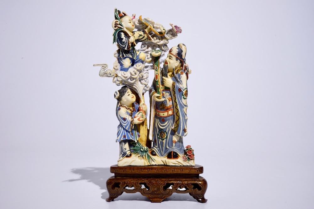 A polychrome Chinese ivory group of an immortal with children, early 20th C.